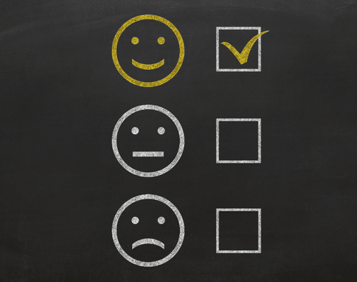 Graphic of chalk-drawn smiley faces and checkboxes, with the happy face checked