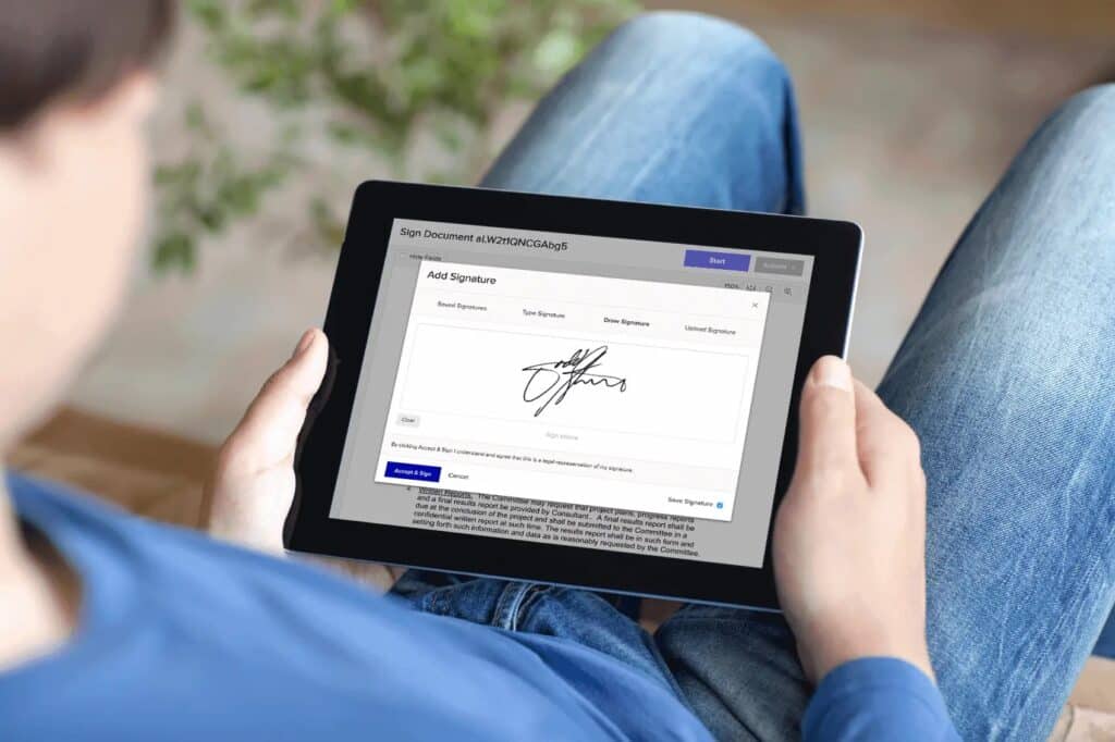 Stock photo of person using a digital signature feature through an iPad application.