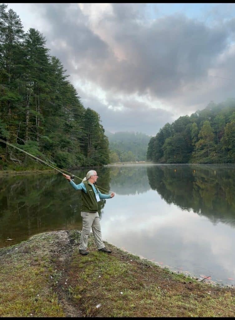 Photo of John fly fishing at the Pause 2023 conference