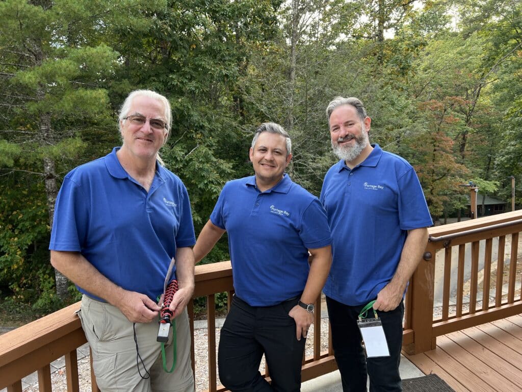Photo of John, Joe, and Xandon wearing their blue Portage Bay Solutions polo shirts.