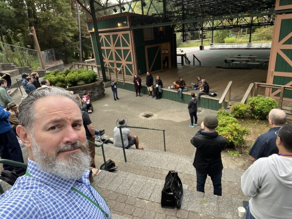 Selfie of Xandon, with the Pause 2023 stage and amphitheater in the background.