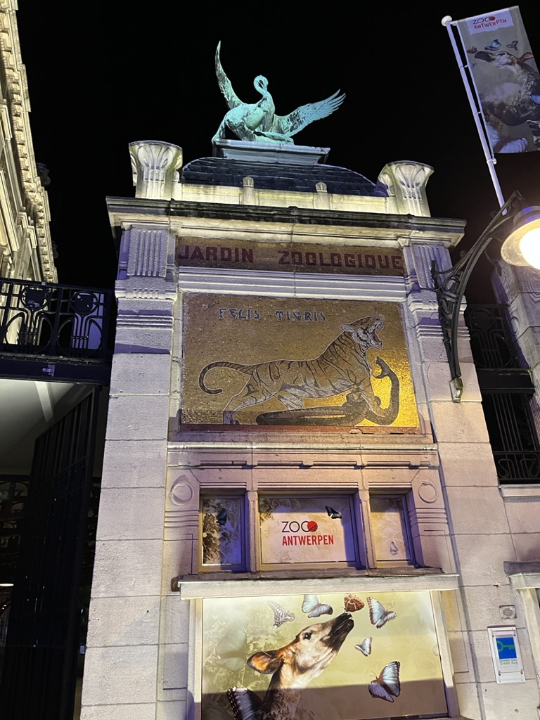 Nighttime photograph of the entrance to the Antwerp Zoo.