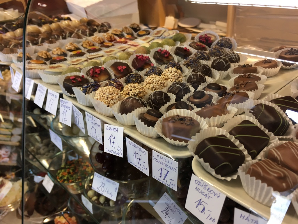 Photo of a large assortment of Belgian chocolates in their display case.