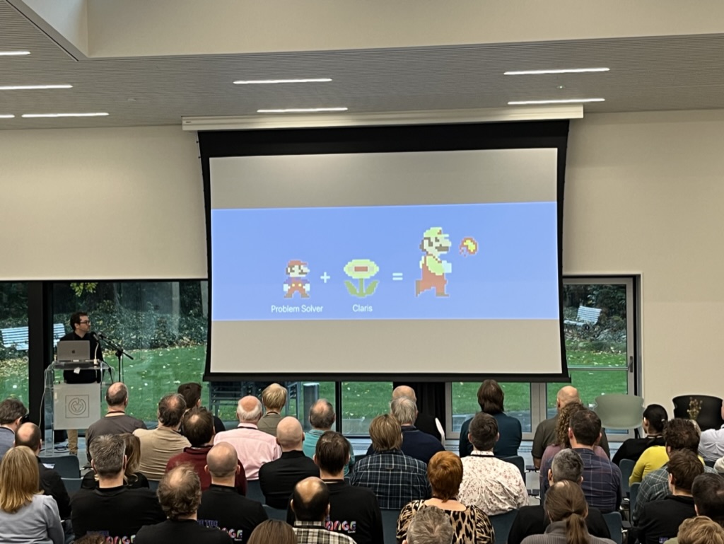 Meeting room with image of Mario Brothers characters displayed on a projector screen.