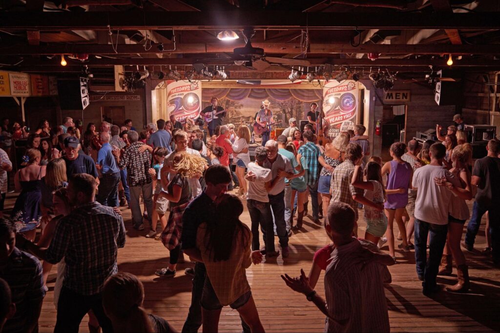 Photograph of people dancing inside Gruene Hall, another Best of Austin destination.
