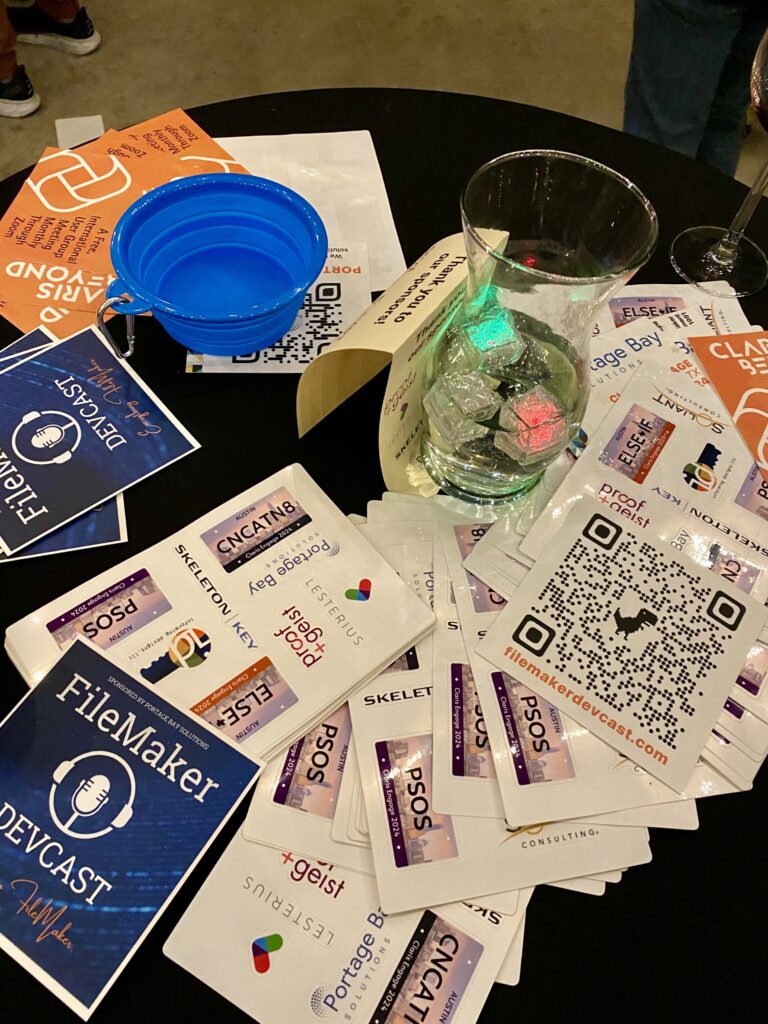 Photo of conference swag on a table at the Claris Engage 2024 Community Party.