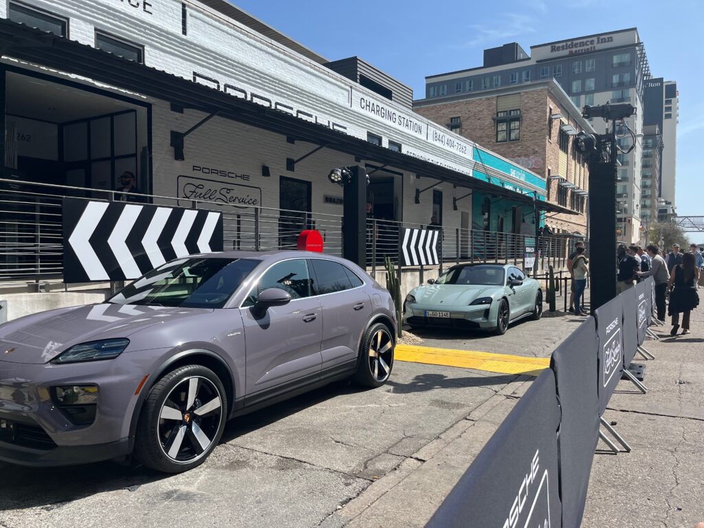 Photo of Porsche cars parked at an electric vehicle charging station outside of SXSW.