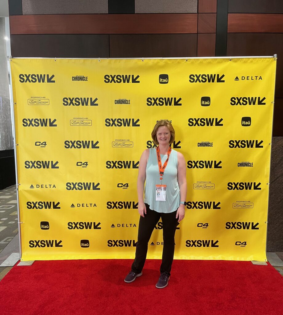 A photo of Kate standing in front of the SXSW conference photo display, which provided the backdrop for her blog article about AI and FileMaker.