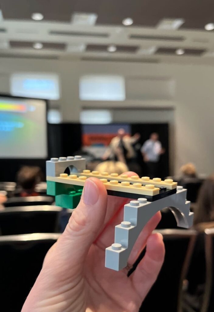 A photo of Kate holding a small creation built out of Legos, made during SXSW.