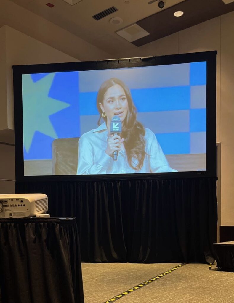 Photograph of video screen showing Meghan Markle's presentation at SXSW.