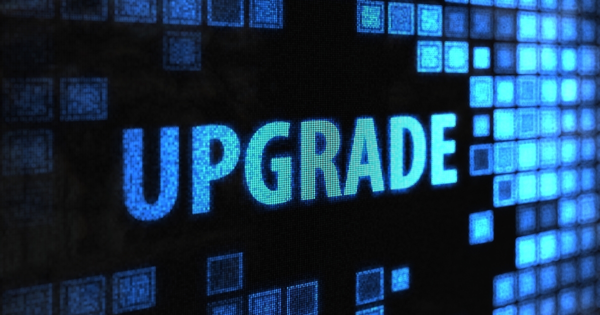 A black background with neon blue squares on the left and big blue ombre letters in the middle that say "UPGRADE"