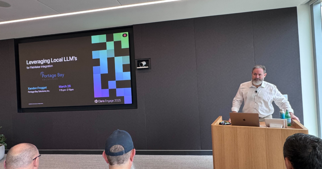 Photo of Xandon Frogget at Claris Engage 2025, in a classroom at the Apple campus in Austin, Texas, presenting his session on leveraging local LLMs in FileMaker