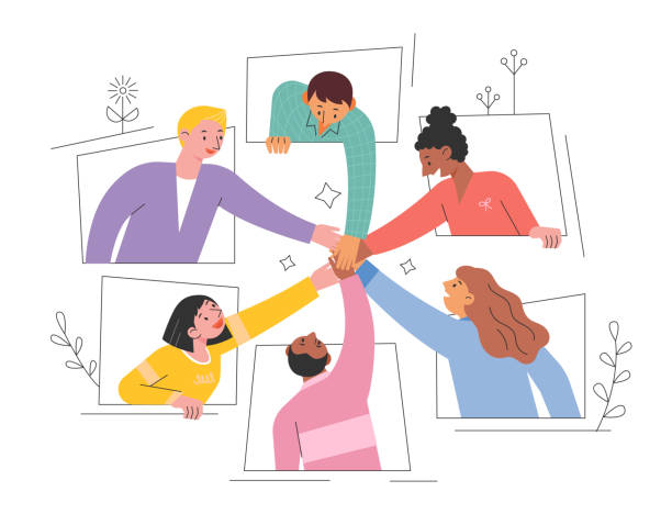 Six people arranged in a circle of sorts, leaning in, each putting one hand into a pile together to signify teamwork. 
